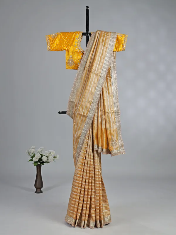 Yellow organza saree with mirror work