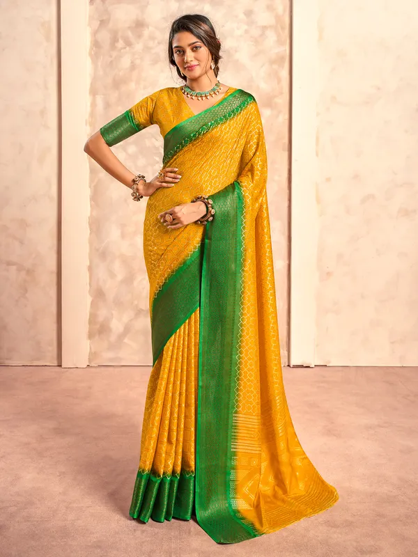 Yellow printed dola silk saree with green border